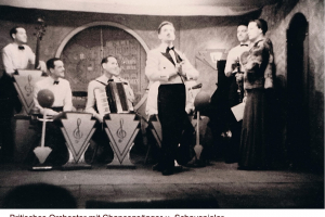 Britisches Orchester mit Chanconsänger u. Schauspieler (Frauen stimmlich imitiert)